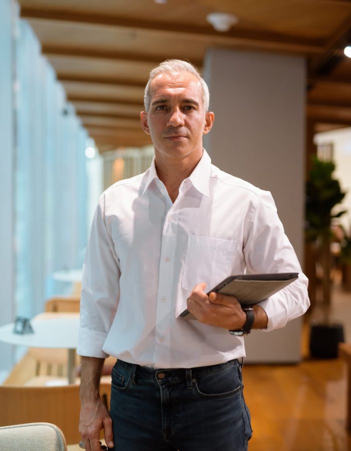 portrait-handsome-businessman-holding-digital-tablet-coffee-shop-vertical-shot